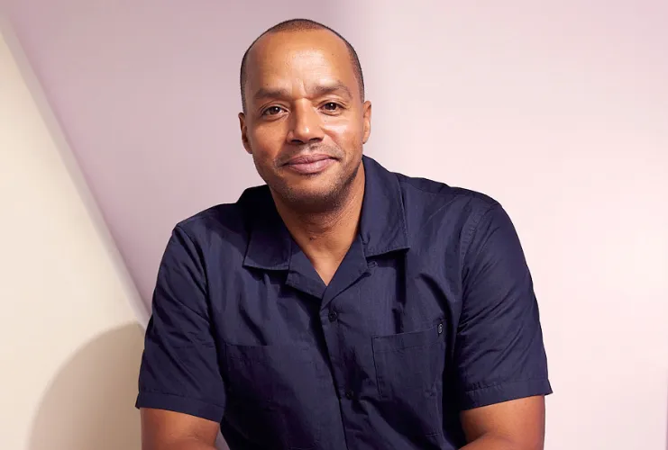 Who Is Donald Faison?
Donald Faison is a well-known American actor, comedian, and voice artist who gained widespread recognition for his energetic personality and memorable performances in television and film. Born June 22, 1974, in Harlem, New York City, United States, Faison has spent more than three decades working in the entertainment industry. He is best known for playing Dr. Christopher Turk in the hit medical comedy series Scrubs. This role made him one of the most recognizable comedic actors on television during the early 2000s.
Faison grew up in a creative environment. His mother, Shirley Faison, worked as a talent agent, which helped introduce him to the entertainment world at an early age. His father, Donald Faison Sr., worked as a building manager. Being surrounded by the industry gave him early exposure to acting opportunities, and he began auditioning as a teenager.
One of his earliest appearances was in a television commercial in the late 1980s. Soon after, he started landing roles in films and television shows. His breakthrough role came in 1995 with the teen comedy Clueless, in which he played Murray Duvall. The film became a cultural phenomenon and later inspired a television series in which Faison reprised the same role.
However, Donald Faison’s career reached new heights when he joined the cast of Scrubs in 2001. His portrayal of Dr. Turk, a talented surgeon with a great sense of humor, earned him widespread popularity and praise. The show ran for several seasons and remains one of the most beloved medical comedies in television history.
Outside of Scrubs, Faison has appeared in several popular films and television series, including Remember the Titans, Uptown Girls, and Kick-Ass 2. He has also worked as a voice actor on animated shows and as a television program host. In addition, he co-hosts the successful podcast “Fake Doctors, Real Friends”, where he and his co-star revisit episodes of Scrubs and share behind-the-scenes stories.
In his personal life, Donald Faison is known for being a devoted family man. He married CaCee Cobb in 2012, and they have children together. With a long-lasting career, multiple successful projects, and a loyal fan base, Donald Faison remains an influential Figure in the entertainment industry.